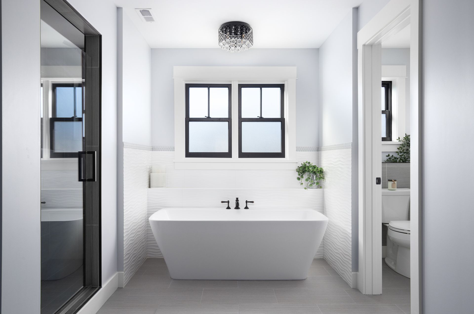Modern bathroom with freestanding tub and walk-in shower, showcasing bathroom remodeling.
