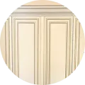 Close-up of off-white wainscoting with decorative molding trim and subtle grey accent lines.
