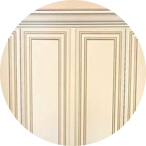 Close-up of off-white wainscoting with decorative molding trim and subtle grey accent lines.