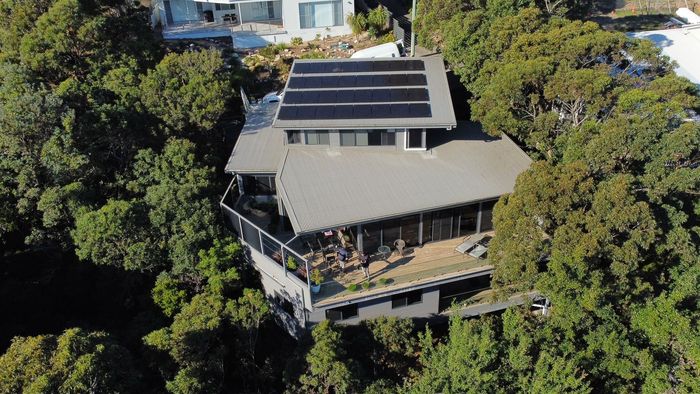 An aerial view of a house surrounded by trees