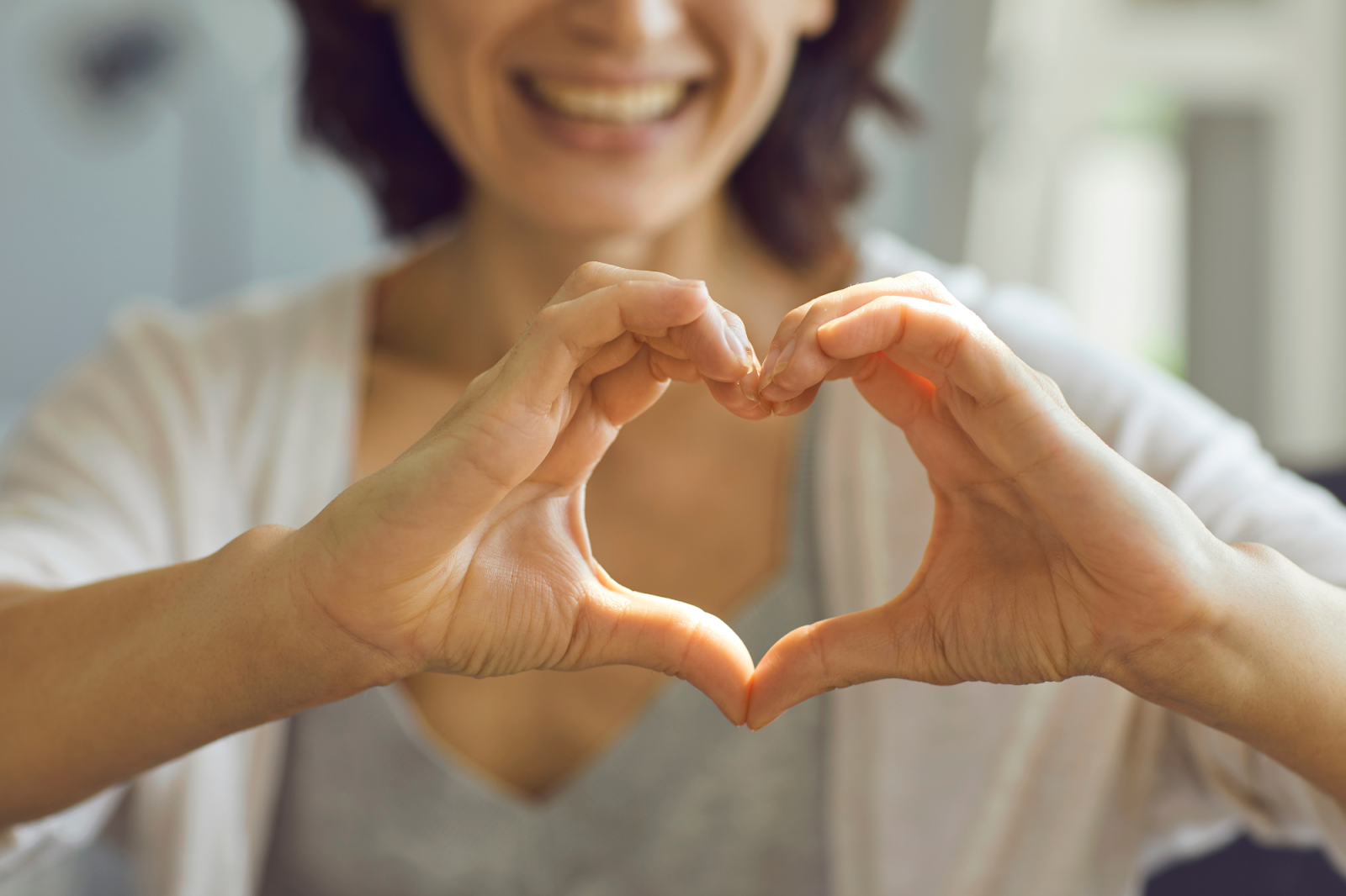A woman smiling, enjoying a healthy life by controlling blood pressure. 
