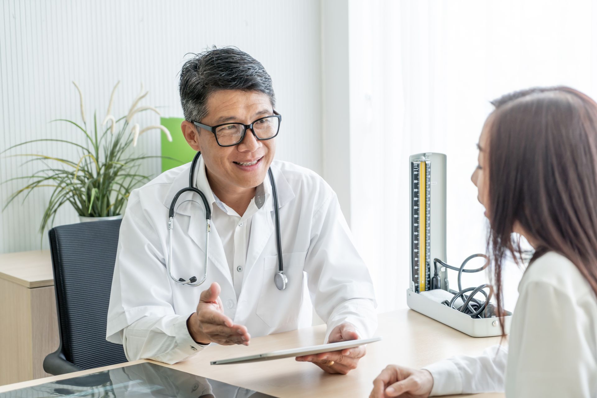 A woman consulting her doctor to find the best treatment for high blood pressure (hypertension).
