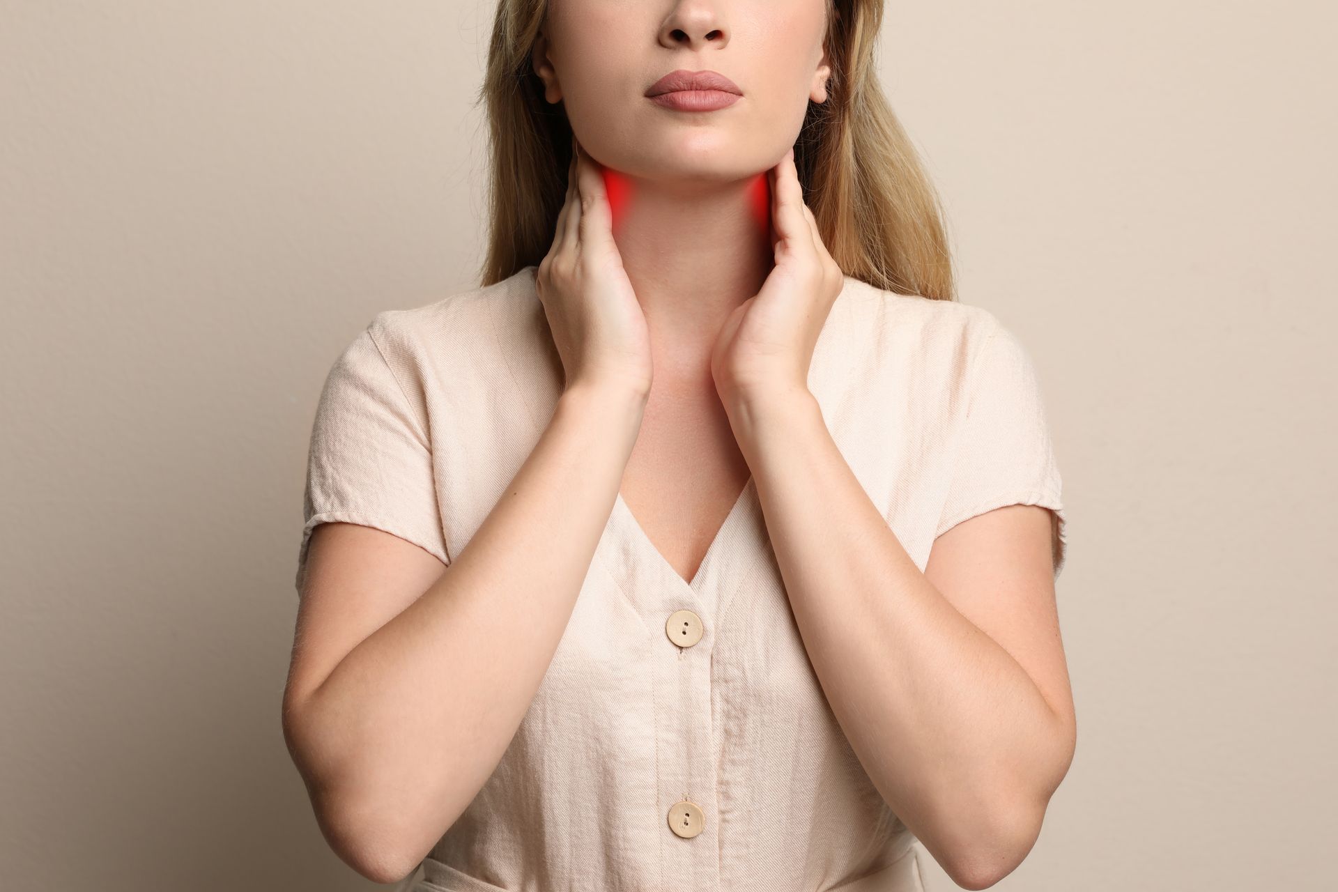 A woman feeling the effects of hyperthyroidism, with symptoms like heart palpitations and difficulty