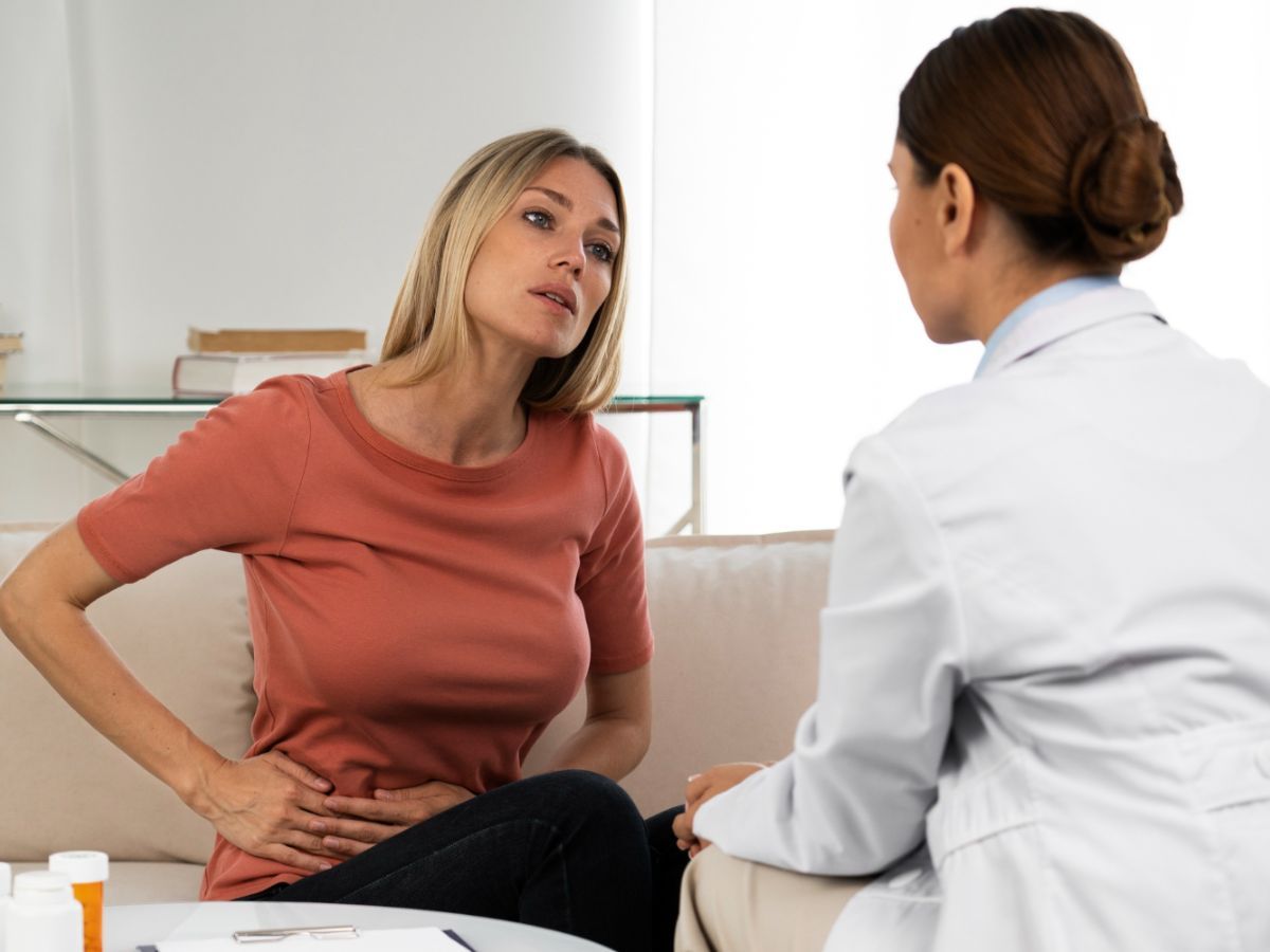 A doctor performing a female health screening on a patient to promote preventive care