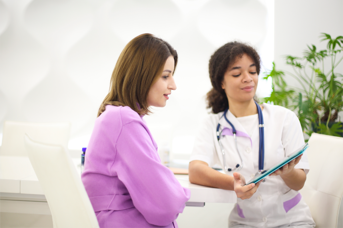 A healthcare professional guiding a woman through her physical check-up results