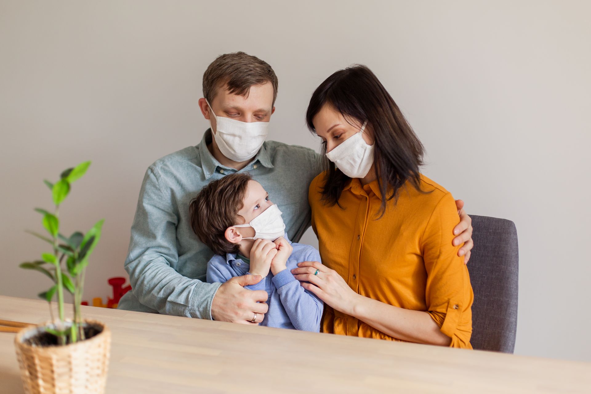 To prioritize RSV prevention, a family of three wears masks.