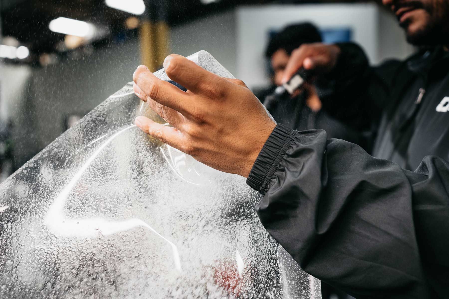 A man is holding a piece of plastic in his hands.