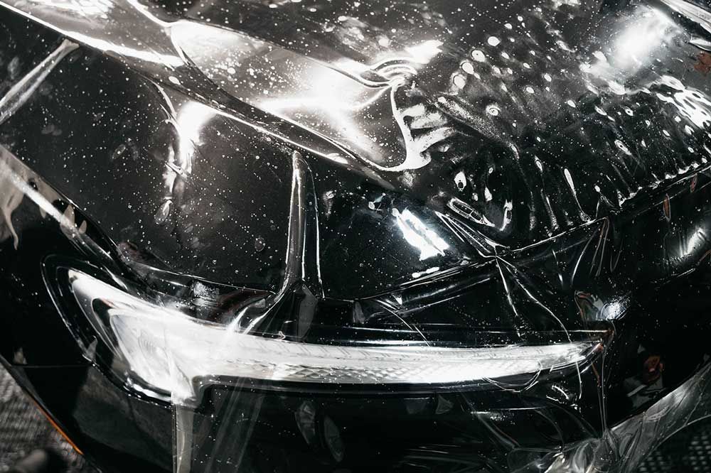 A close up of a car covered in a PPF. 