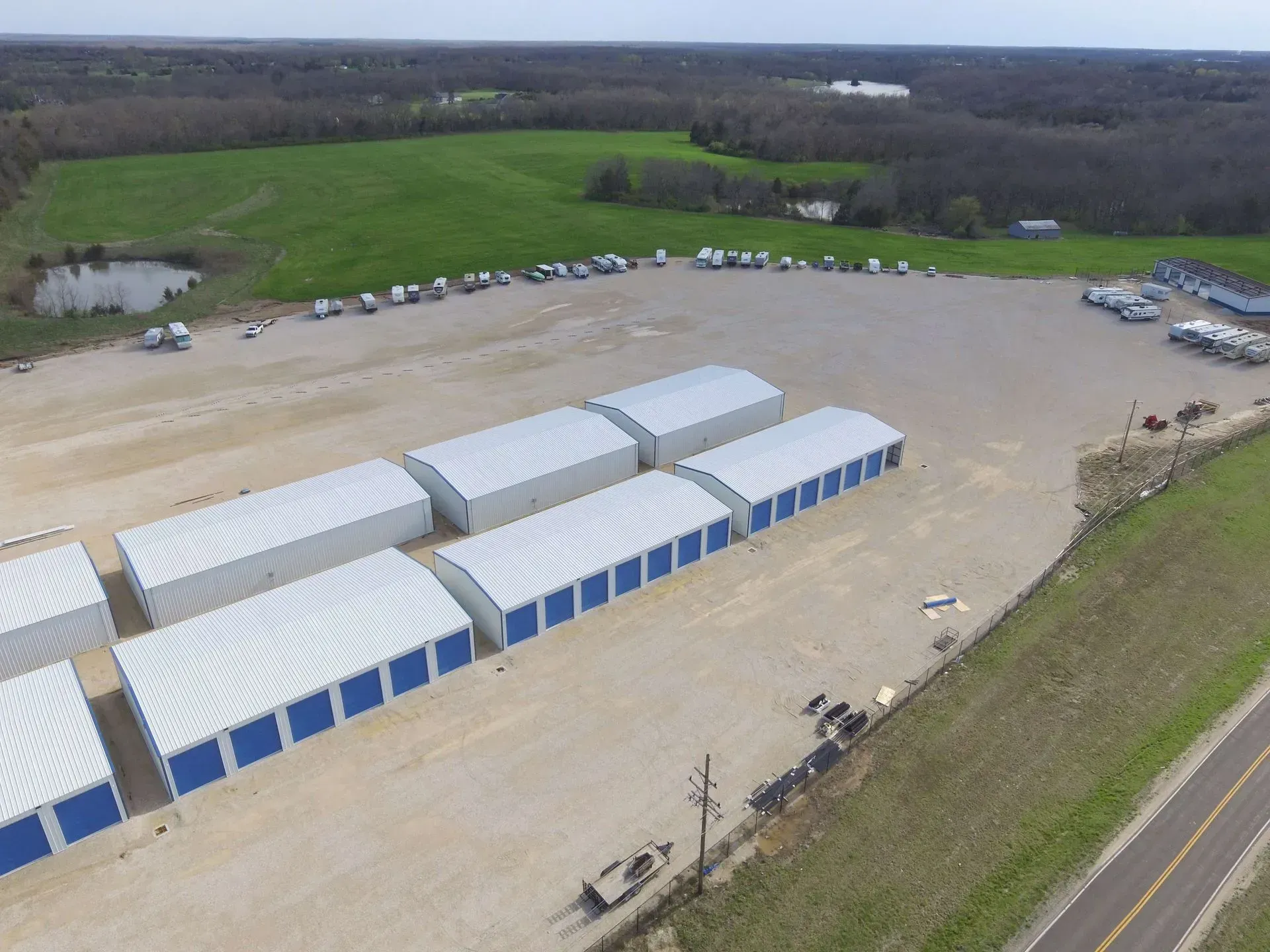 An aerial view of a row of storage units in a parking lot.