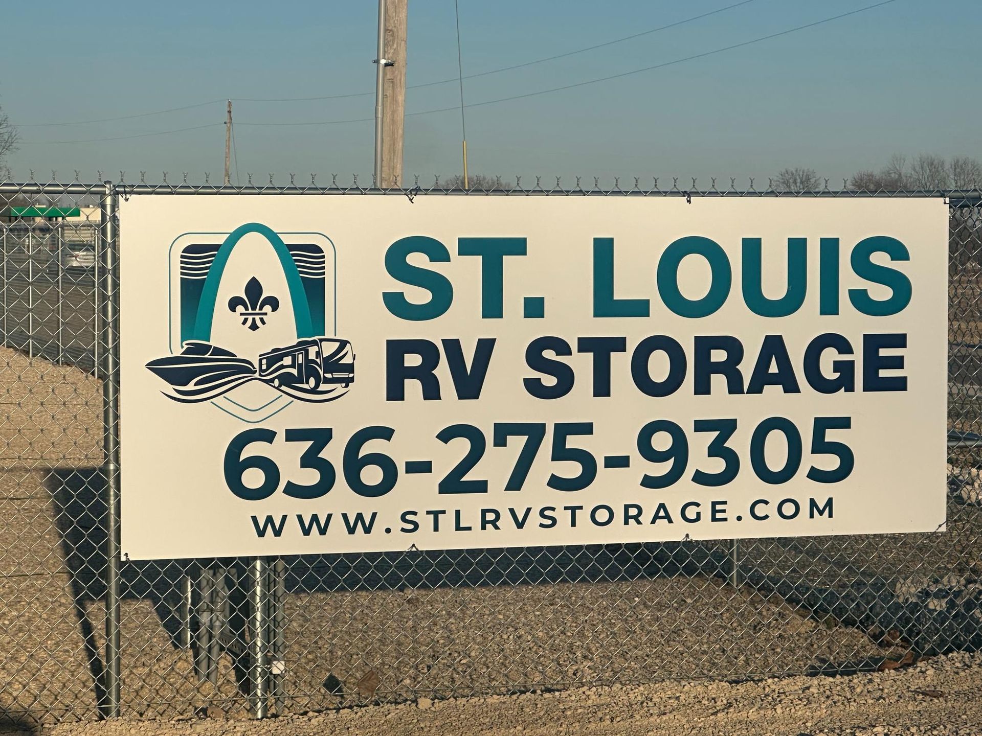 Sign for St. Louis RV Storage; phone number, website, logo of the Gateway Arch and boats.