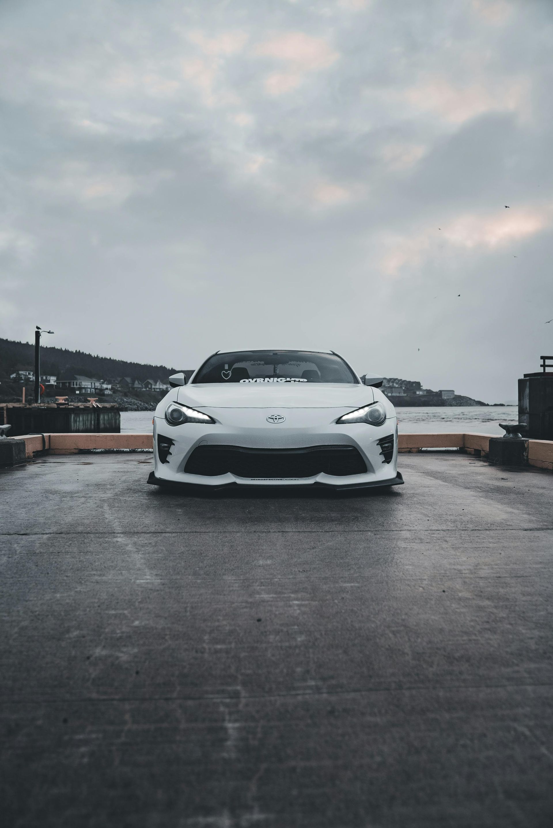 A black truck is parked in front of a building.