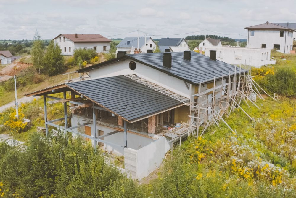House Under Construction With Black Roof and Scaffolding — MJD Roofing Sunshine Coast in Cooroy, QLD