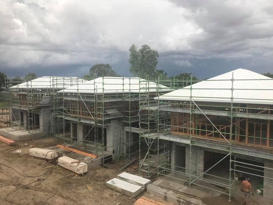 Houses Under Construction With Scaffolding, Cloudy Sky in Background — MJD Roofing Sunshine Coast in Cooroy, QLD