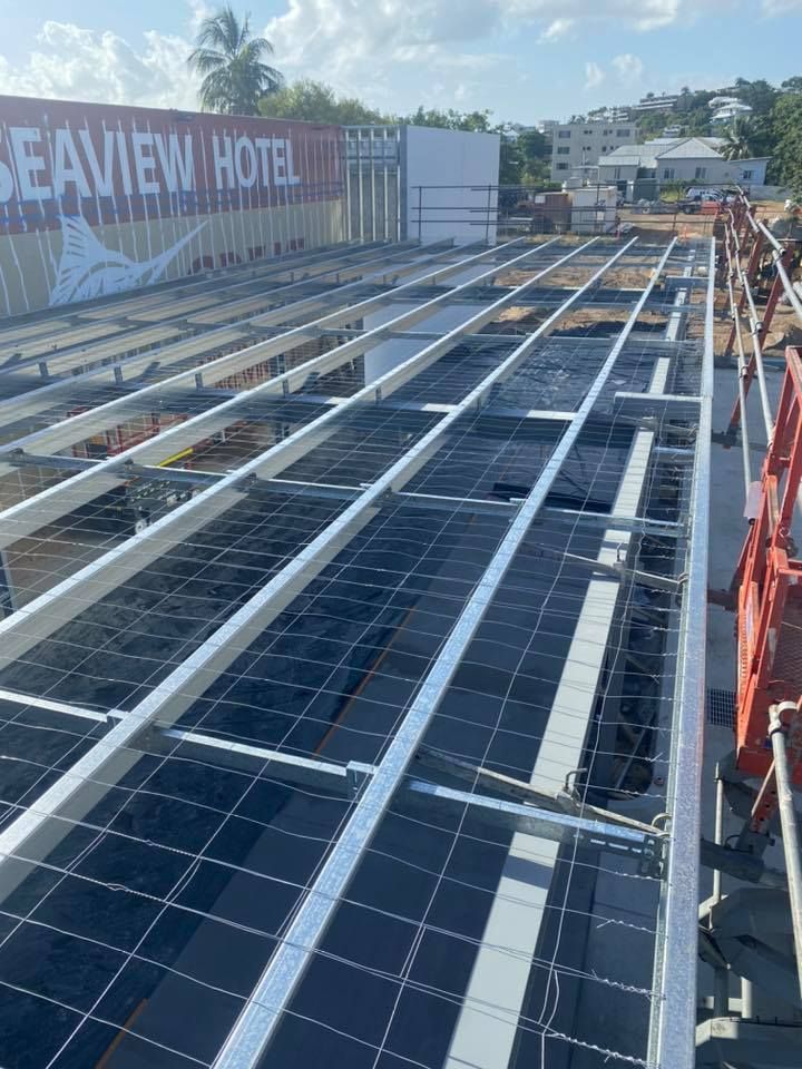 Solar Panel Installation on a Hotel Roof, With a Grid Structure — MJD Roofing Sunshine Coast in Cooroy, QLD