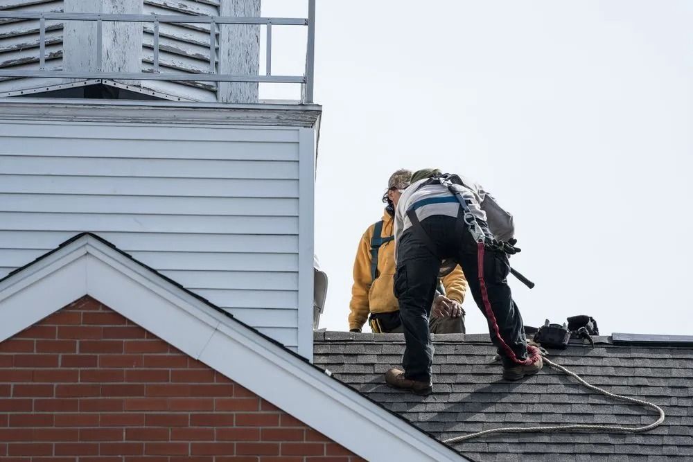 Workers on a Church Roof One in Safety Harness — MJD Roofing Sunshine Coast in Sunshine Coast, QLD
