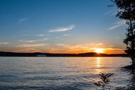 The sun is setting over a large body of water.