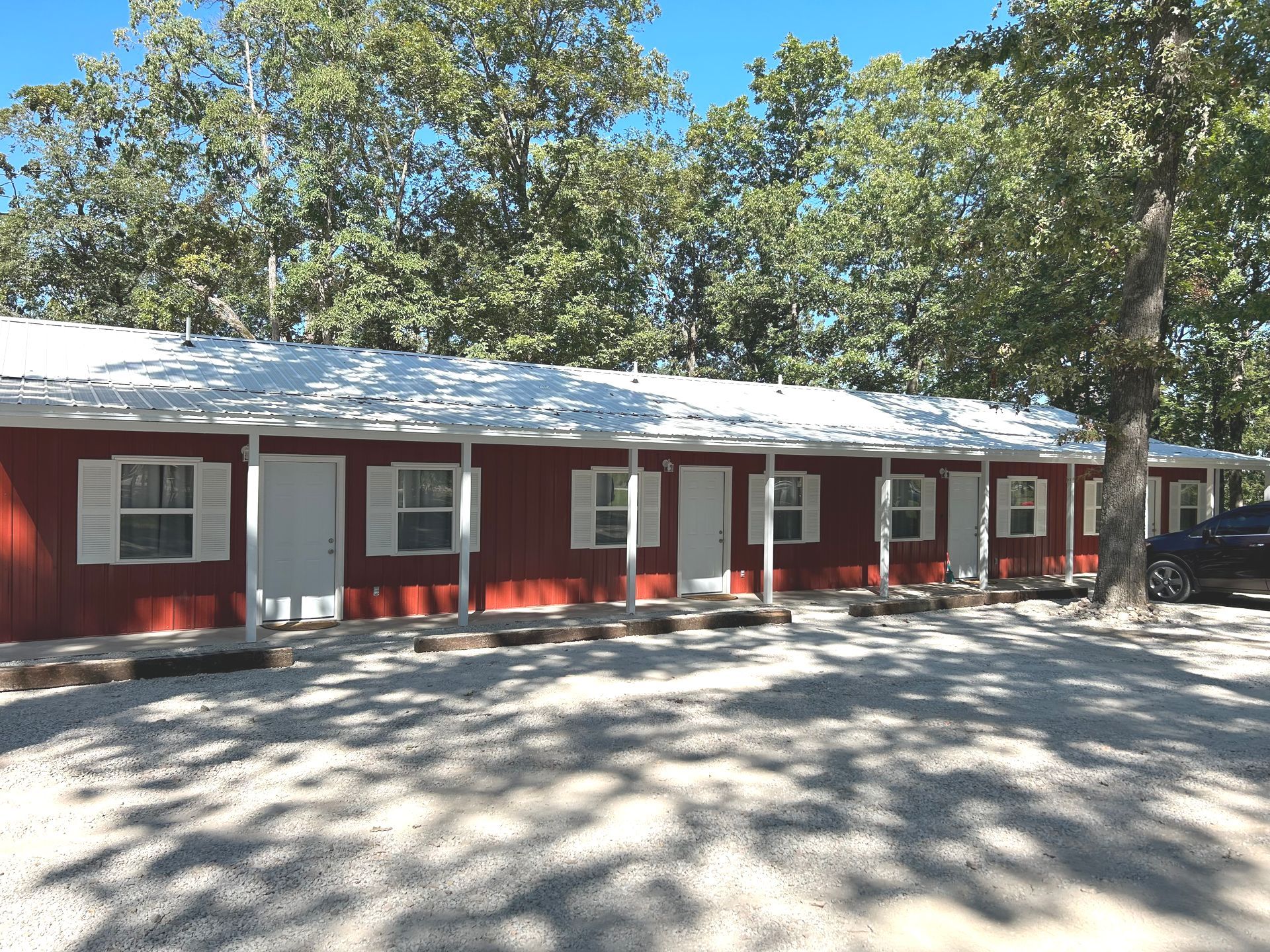 A red house with white shutters and a white roof