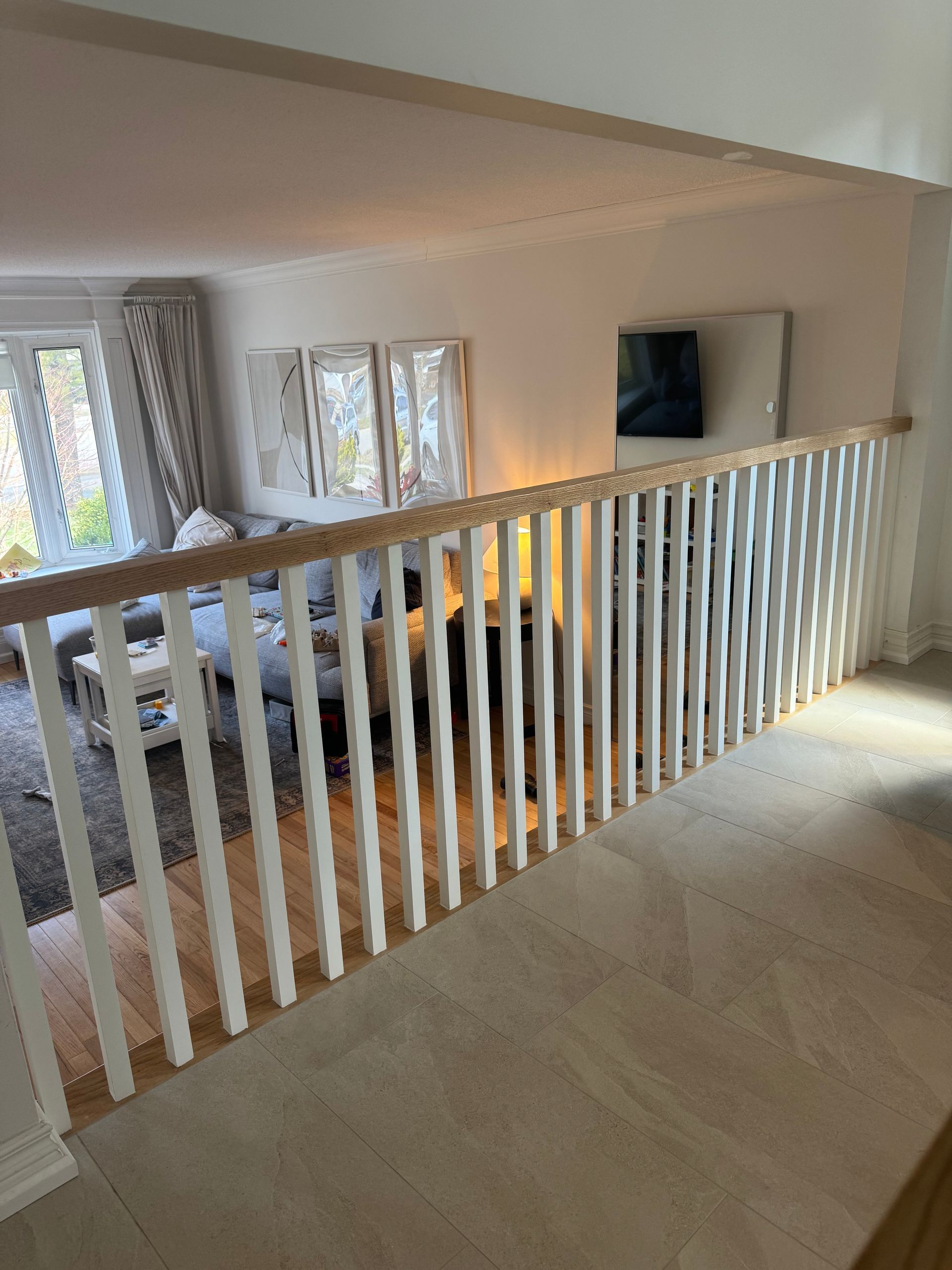 A living room with a white railing and a couch