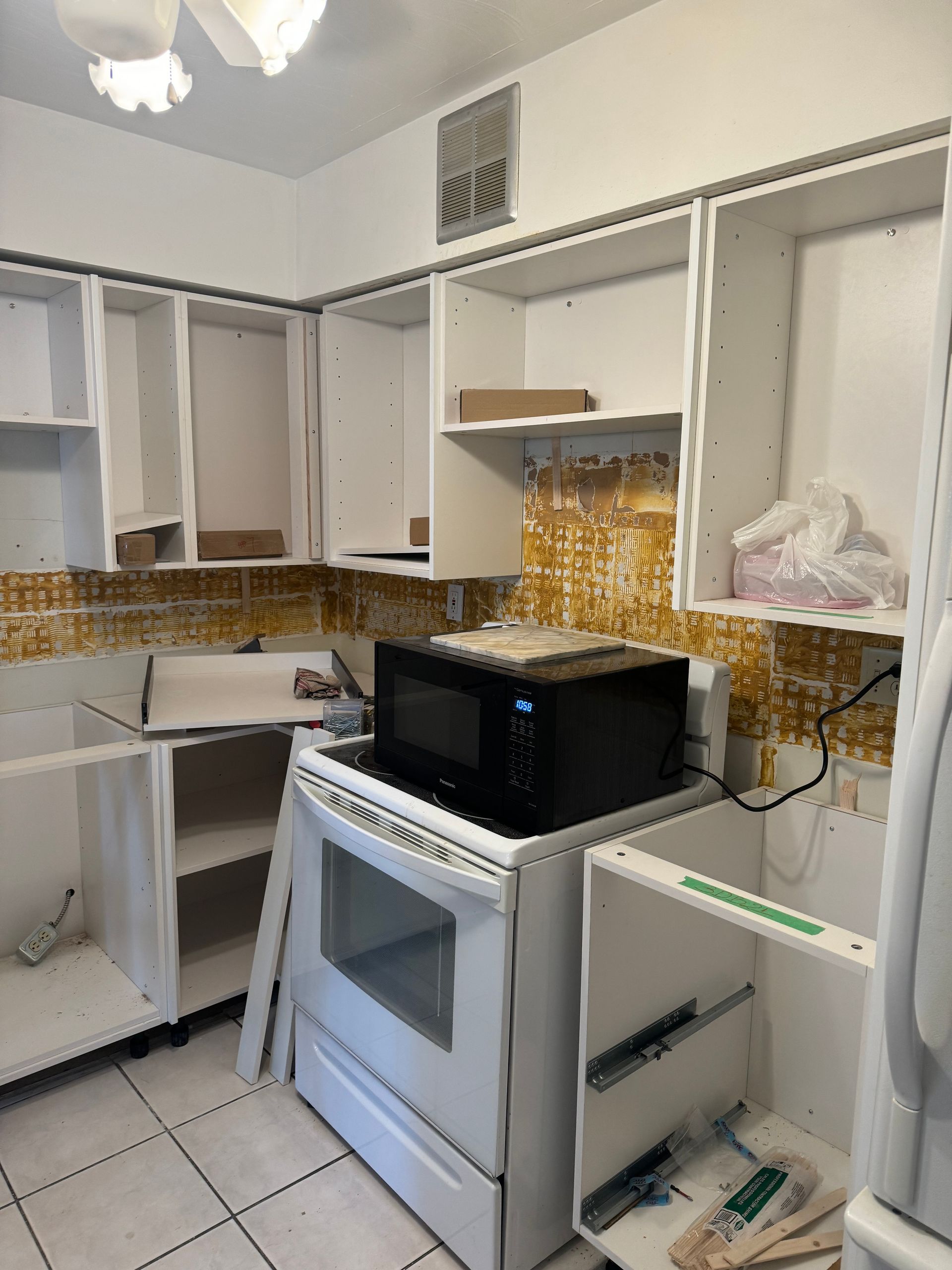 A kitchen with a microwave on top of a stove