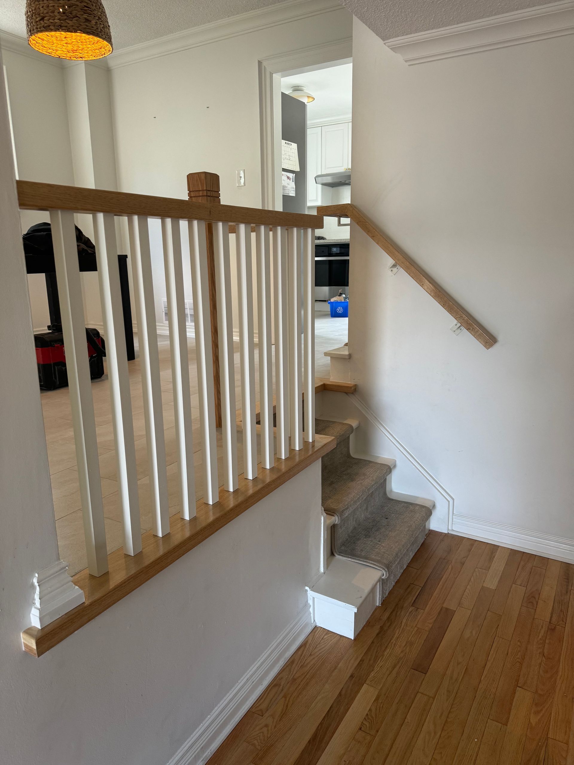 A staircase with a white railing and wooden steps