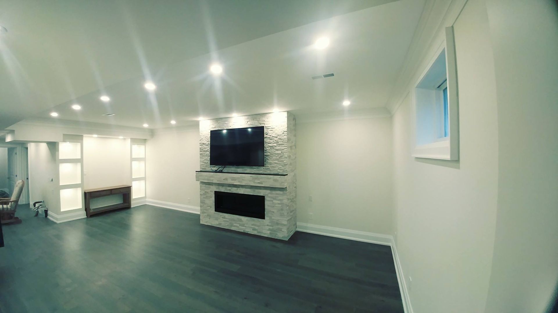 A living room with a fireplace and a flat screen tv