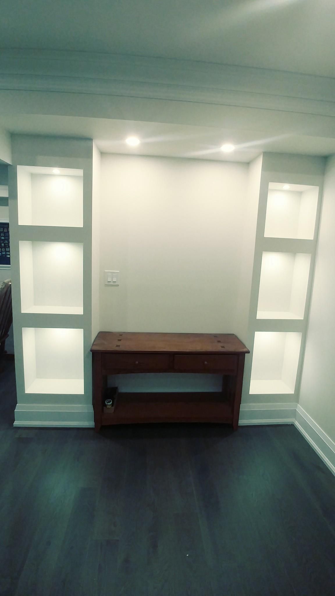 An empty room with shelves and a wooden table