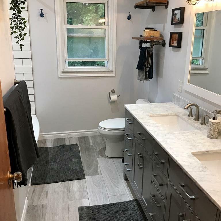 A bathroom with a toilet , sink , and mirror.