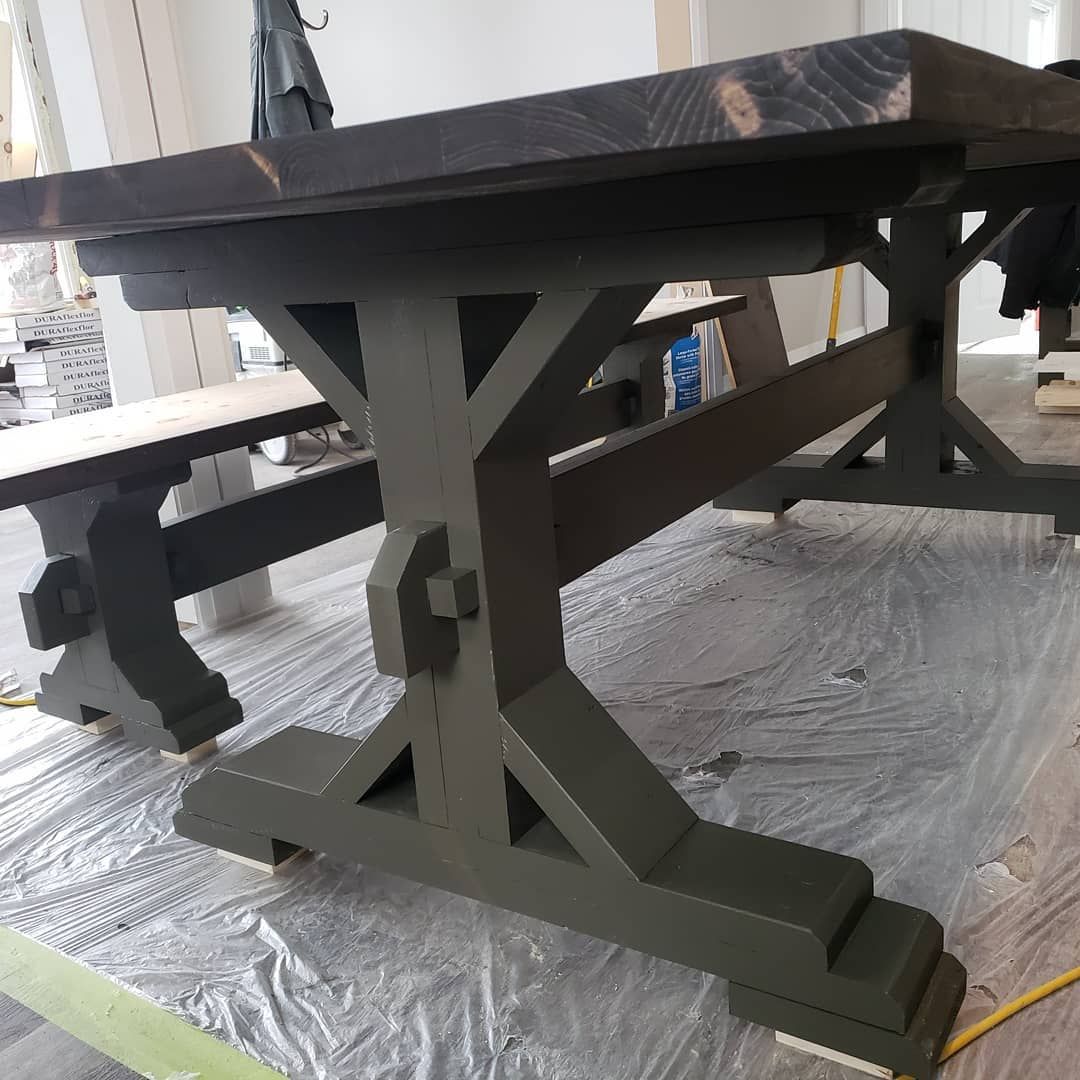 A wooden table with a bench underneath it