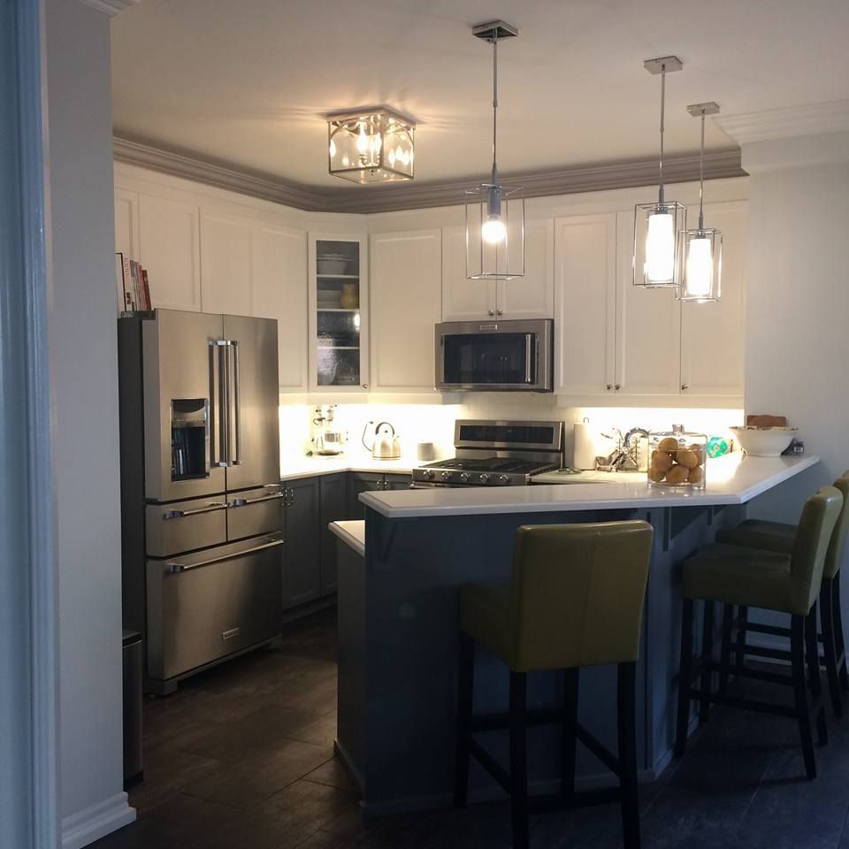 A kitchen with stainless steel appliances and white cabinets