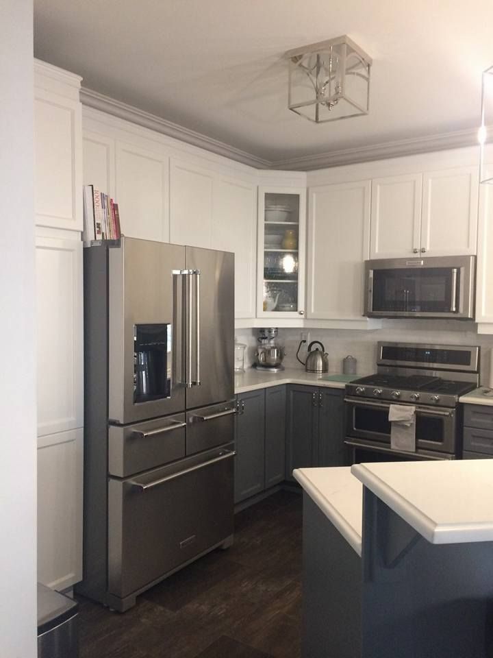 A kitchen with stainless steel appliances and white cabinets