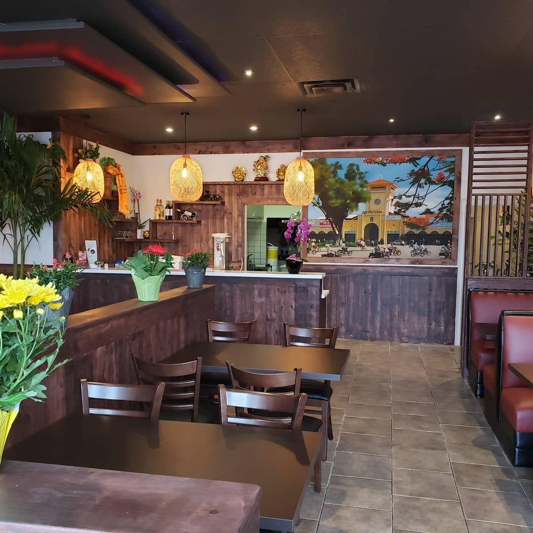 The inside of a restaurant with tables and chairs