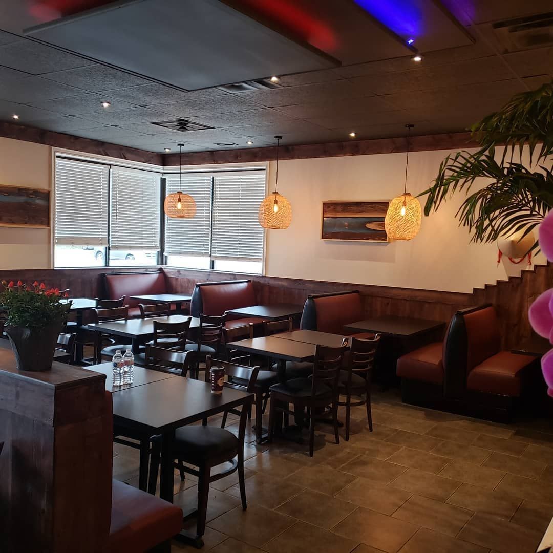 The inside of a restaurant with tables and chairs
