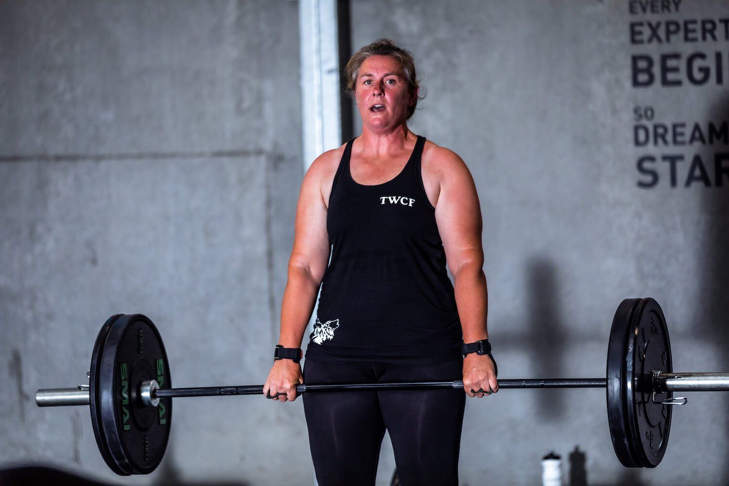 Image of woman crossfit training running along while thinking about fitness