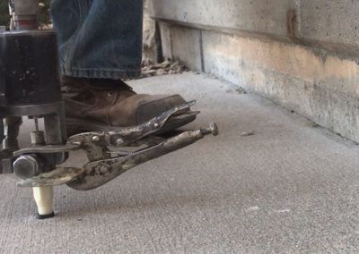 A close up of a person 's foot with a wrench on it.