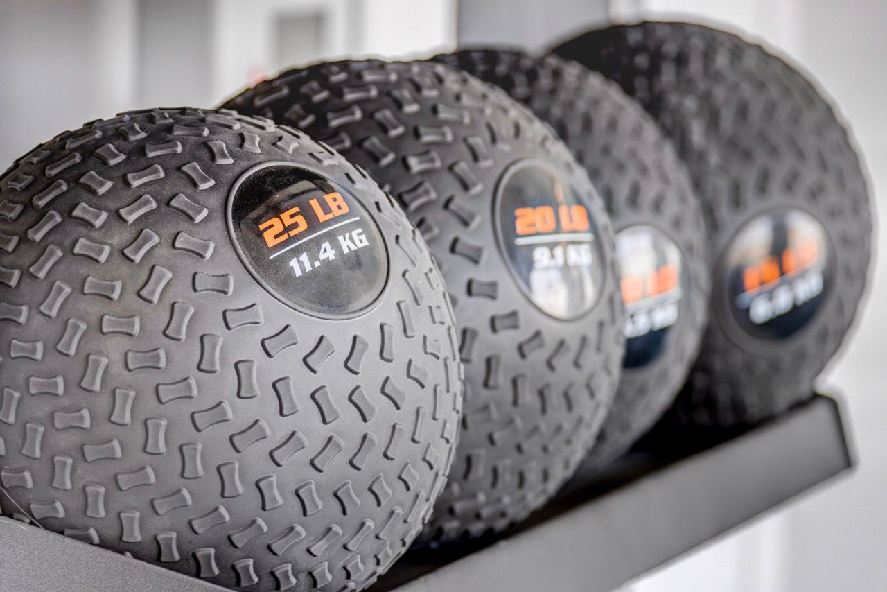 Aria dumbbells on a rack in the apartment gym.
