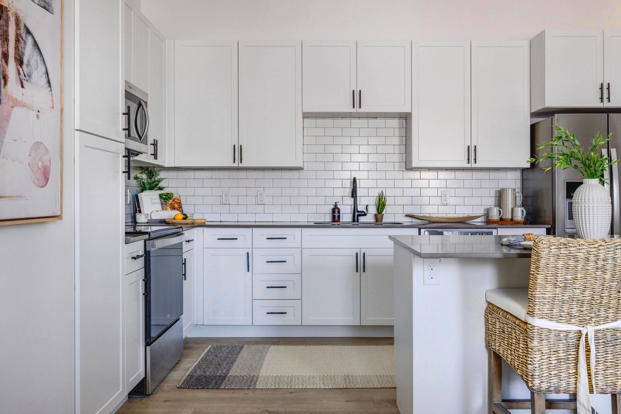 Aria kitchen with subway tile backsplash, stainless appliances, and a central island.