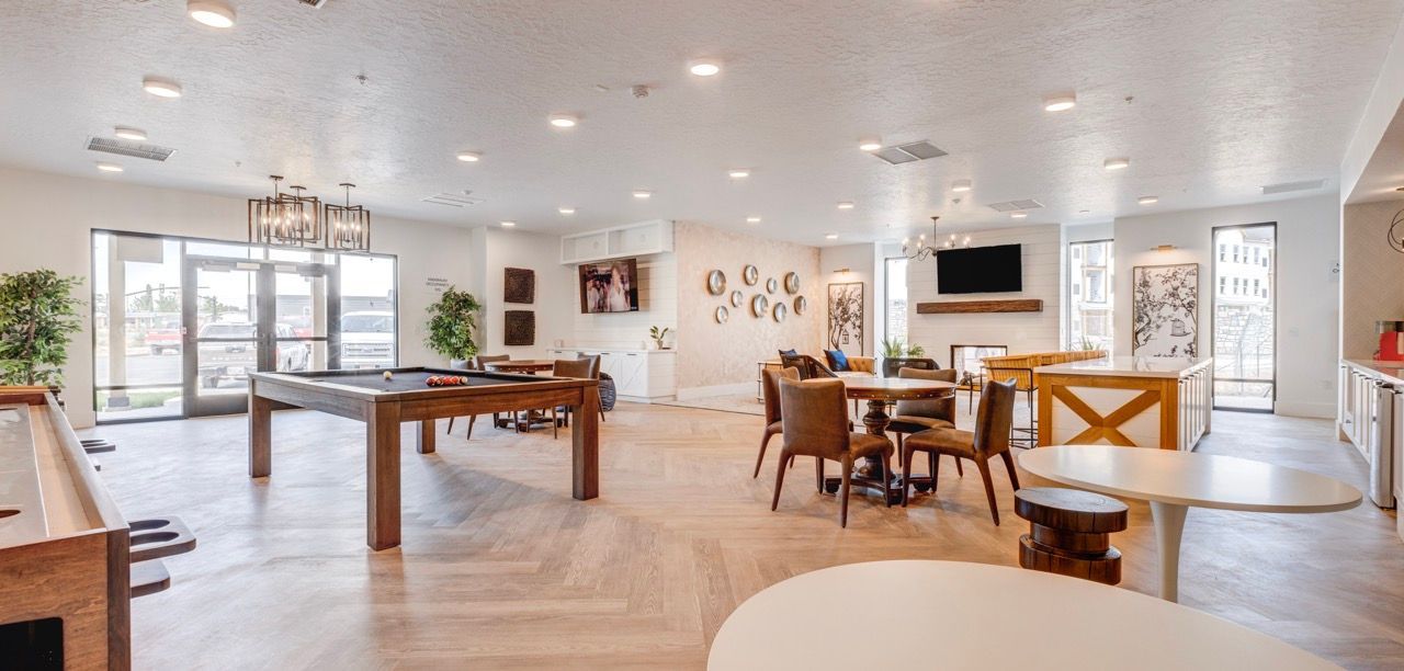 Aria communal lounge with a pool table, round tables, and comfortable seating.