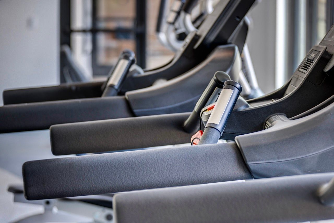 Aria Rows of treadmills in an apartment community gym.