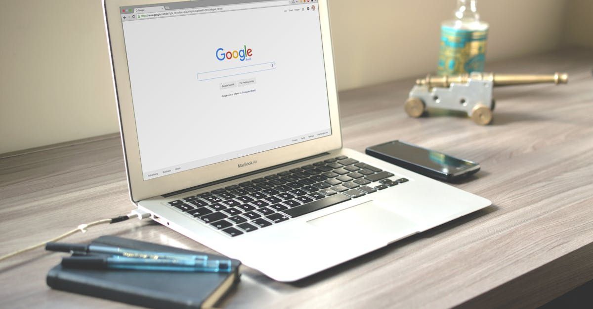 A laptop computer is open to a google page on a wooden desk.