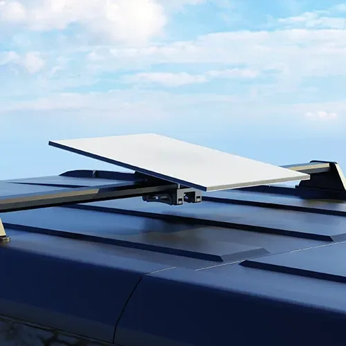 A satellite dish is sitting on top of a blue roof.