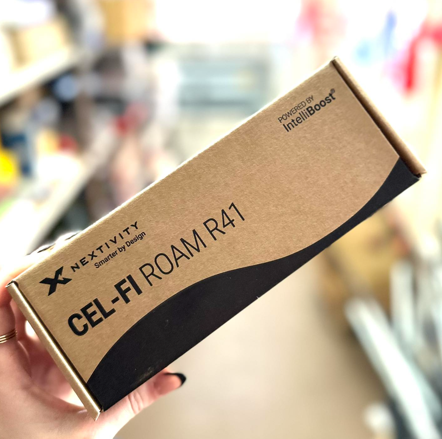 A person is holding a box that says cel-fi roam r41