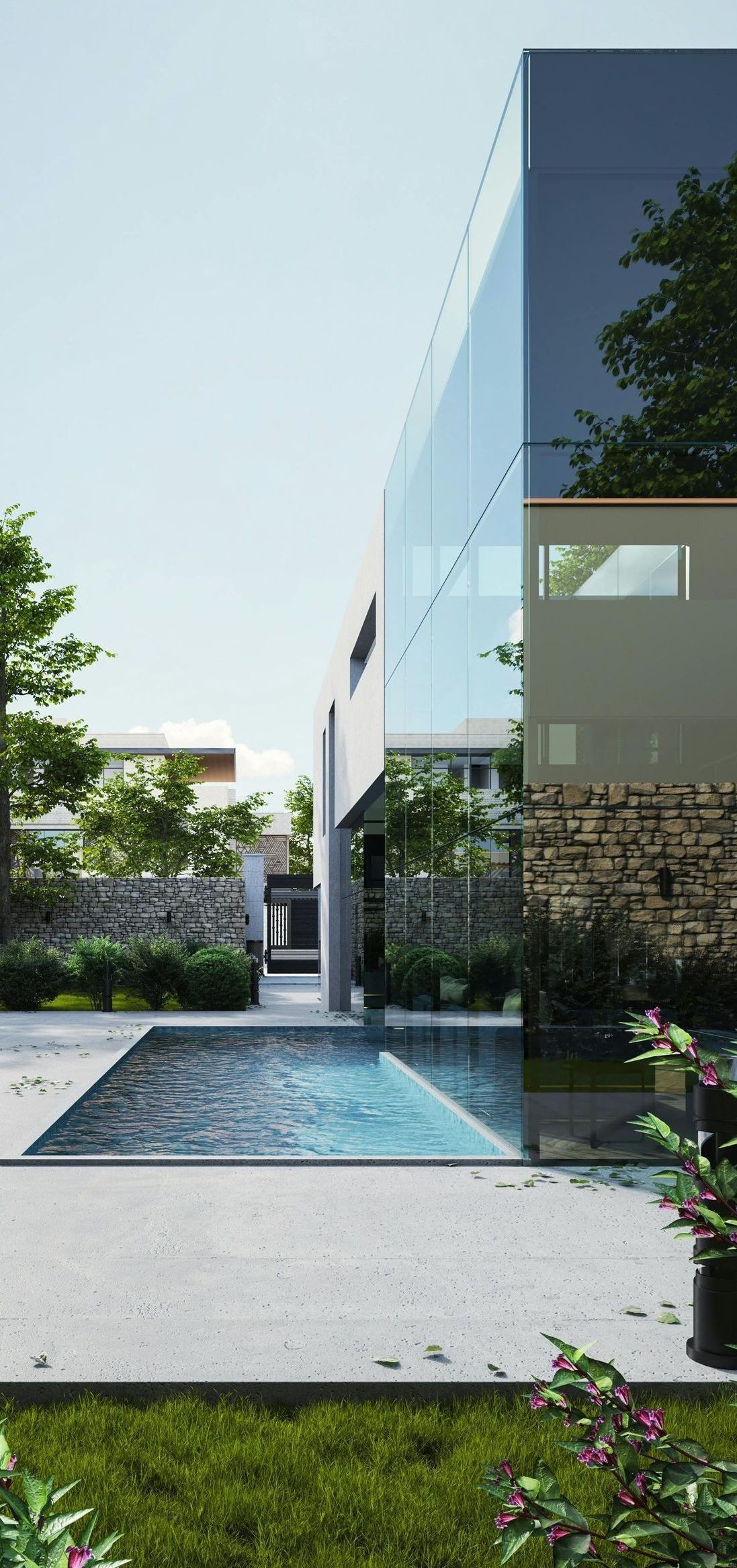 A modern house with a large swimming pool in front of it.