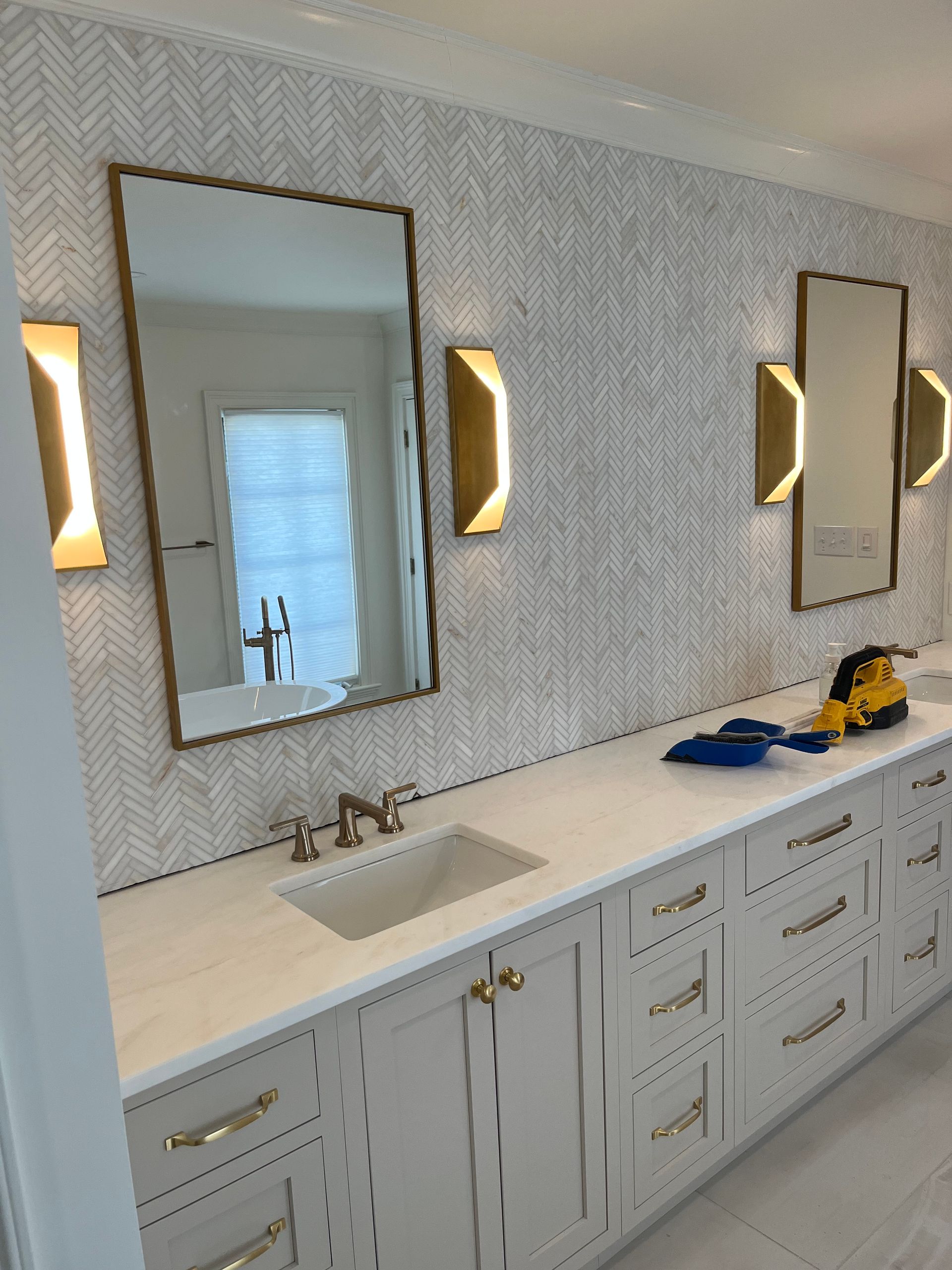 a bathroom with two sinks and two mirrors on the wall .