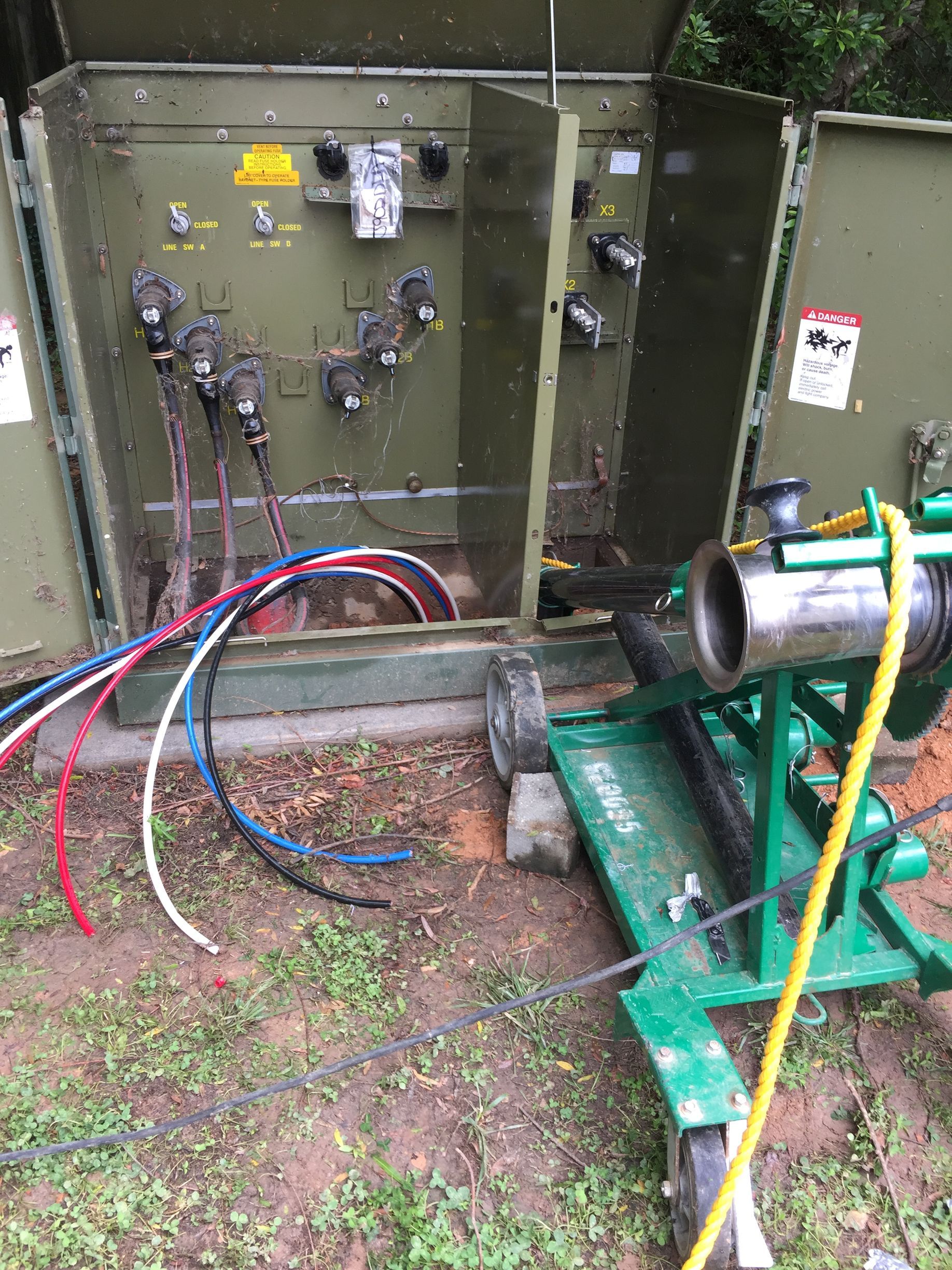 a green box with a bunch of wires coming out of it .