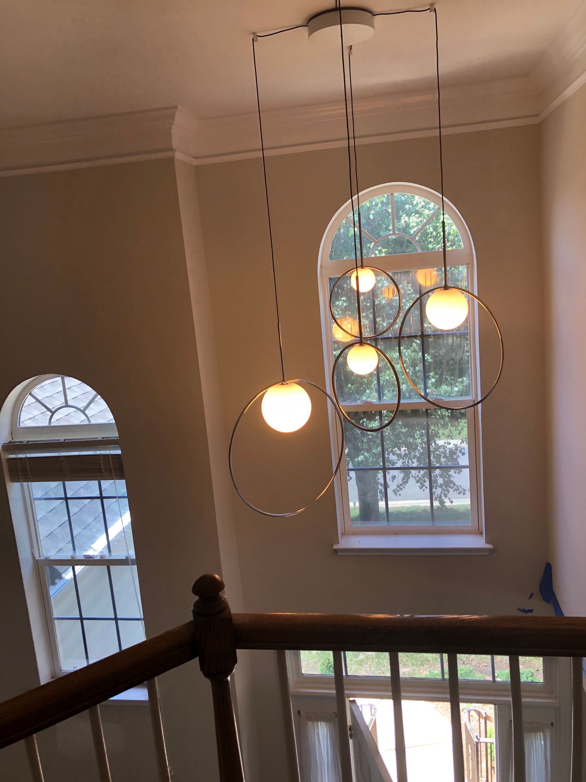 a staircase with a chandelier hanging from the ceiling