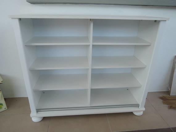 White wooden bookshelf with six shelves, two columns, and a rounded base.