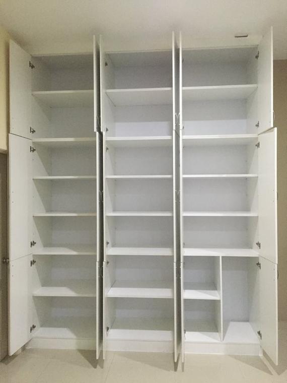 White open cabinets with multiple shelves; built into a wall.