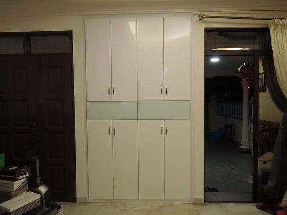White closet with eight doors, a door on left, and an open door to a patio on right.