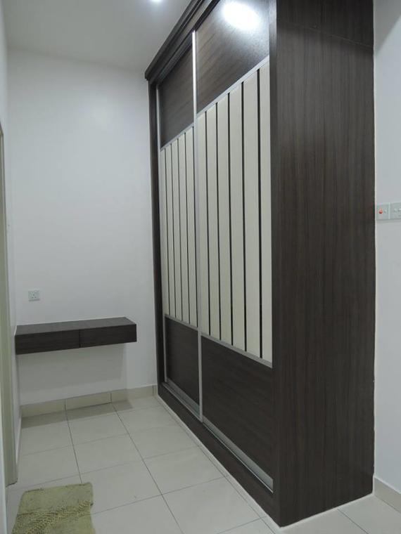 Dark wood closet with sliding doors, white vertical panels. White walls, light-colored tile floor. Small shelf on left.