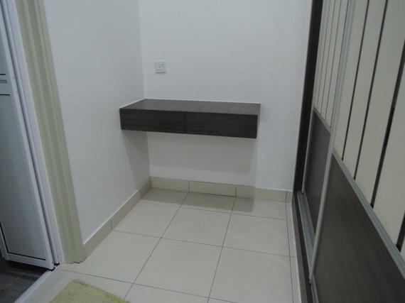 Dark brown floating shelf on a white wall, over tiled floor, near a doorway.
